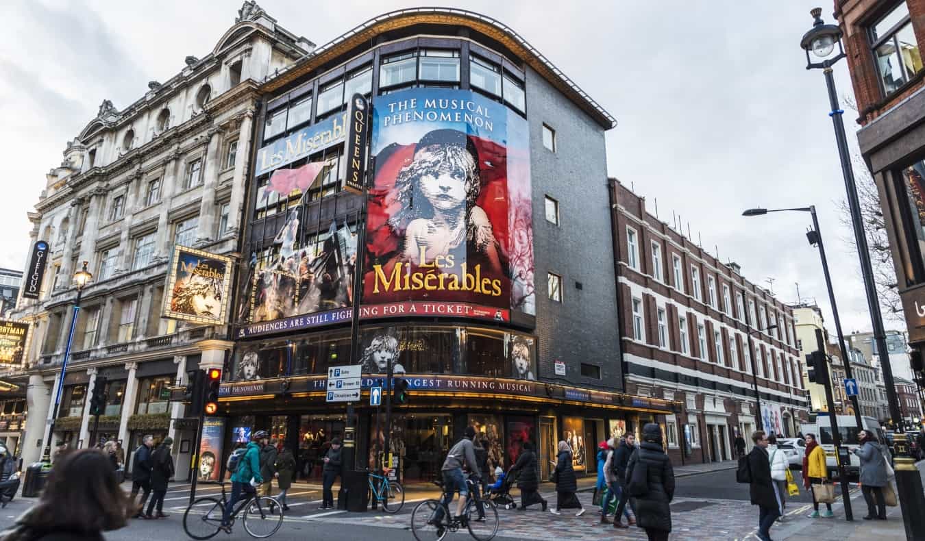Facade of the Queen's Theatre announcing the play Les Miserables in Shaftesbury Avenue in London, UK