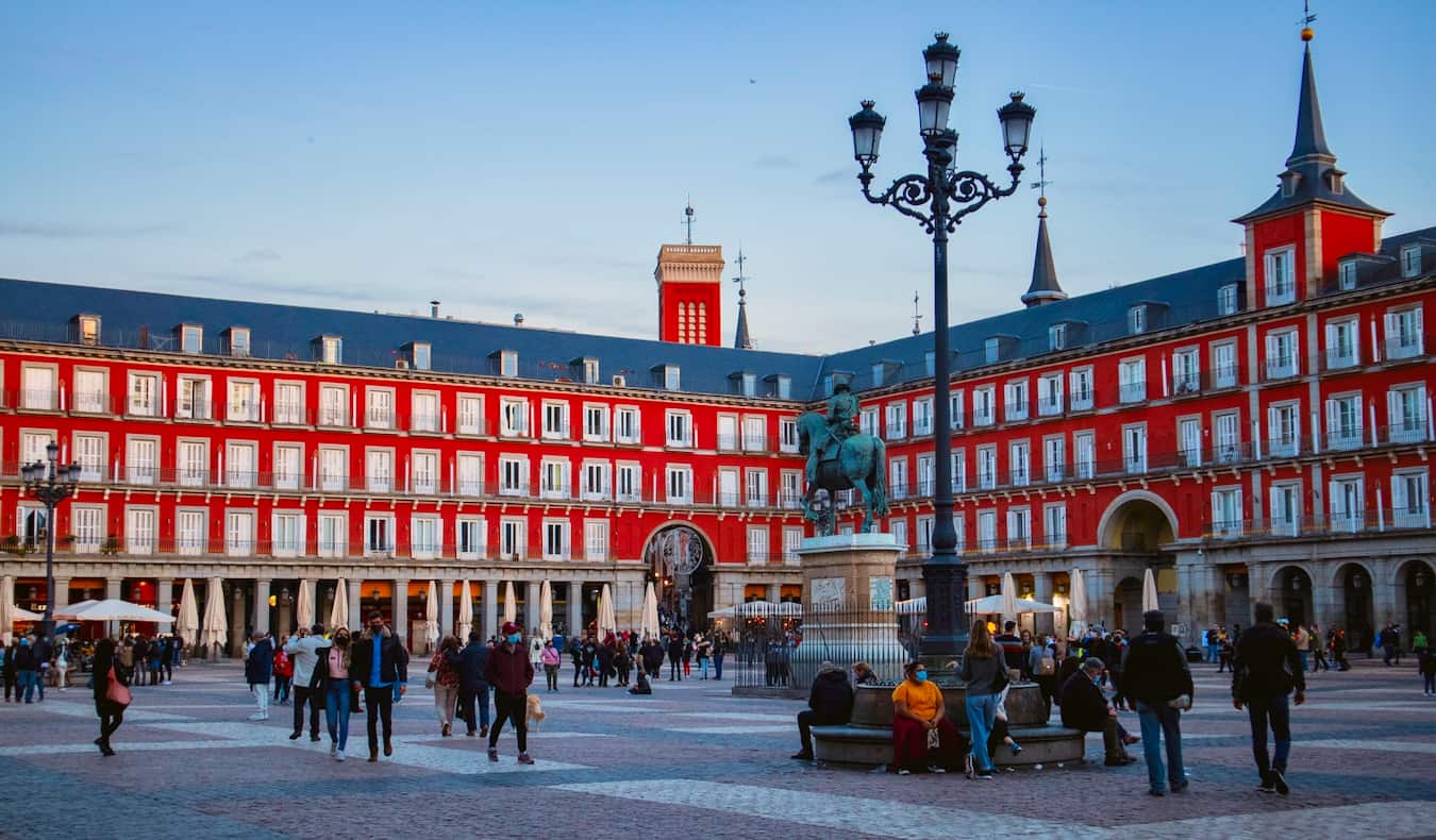 People enjoying the busy plaza mayor in Madrid, Spain on a sunny summer day
