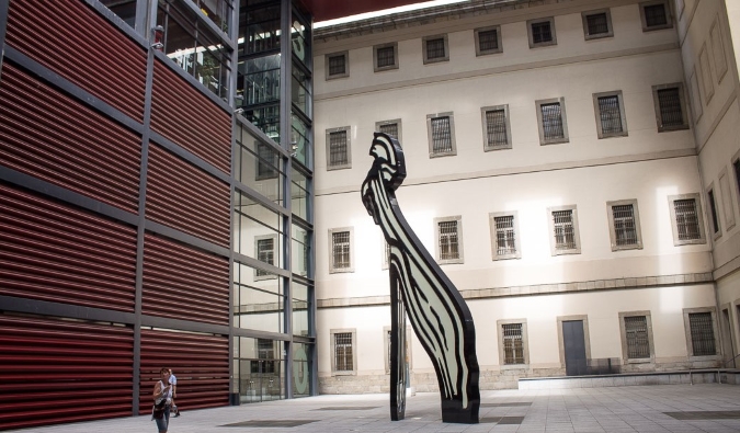 The expansive inner courtyard with a large sculpture in the middle at the Reina Sofia Museum in Madrid, Spain