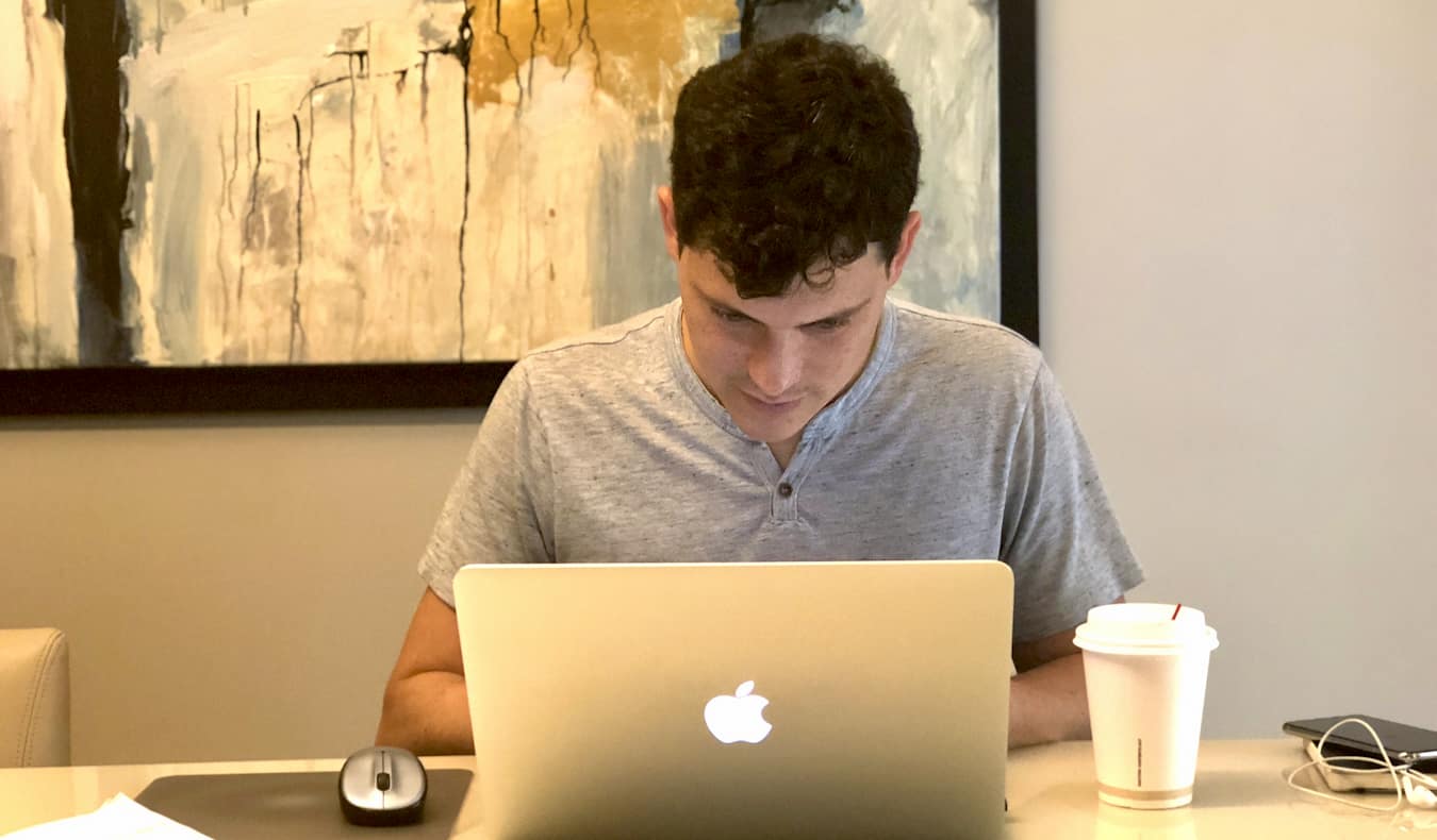 Matt Kepnes of Nomadic Matt working on a laptop at a desk