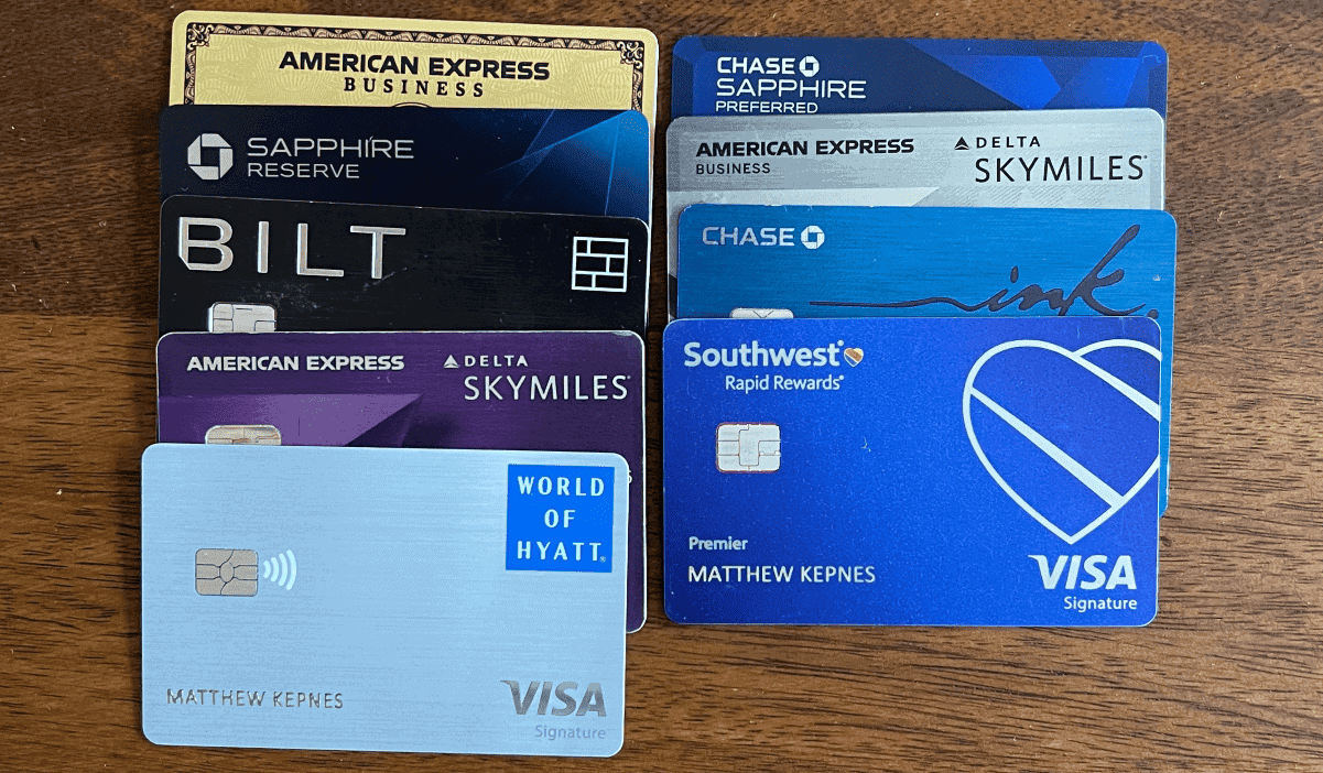 A variety of credit cards lined up on a wooden table