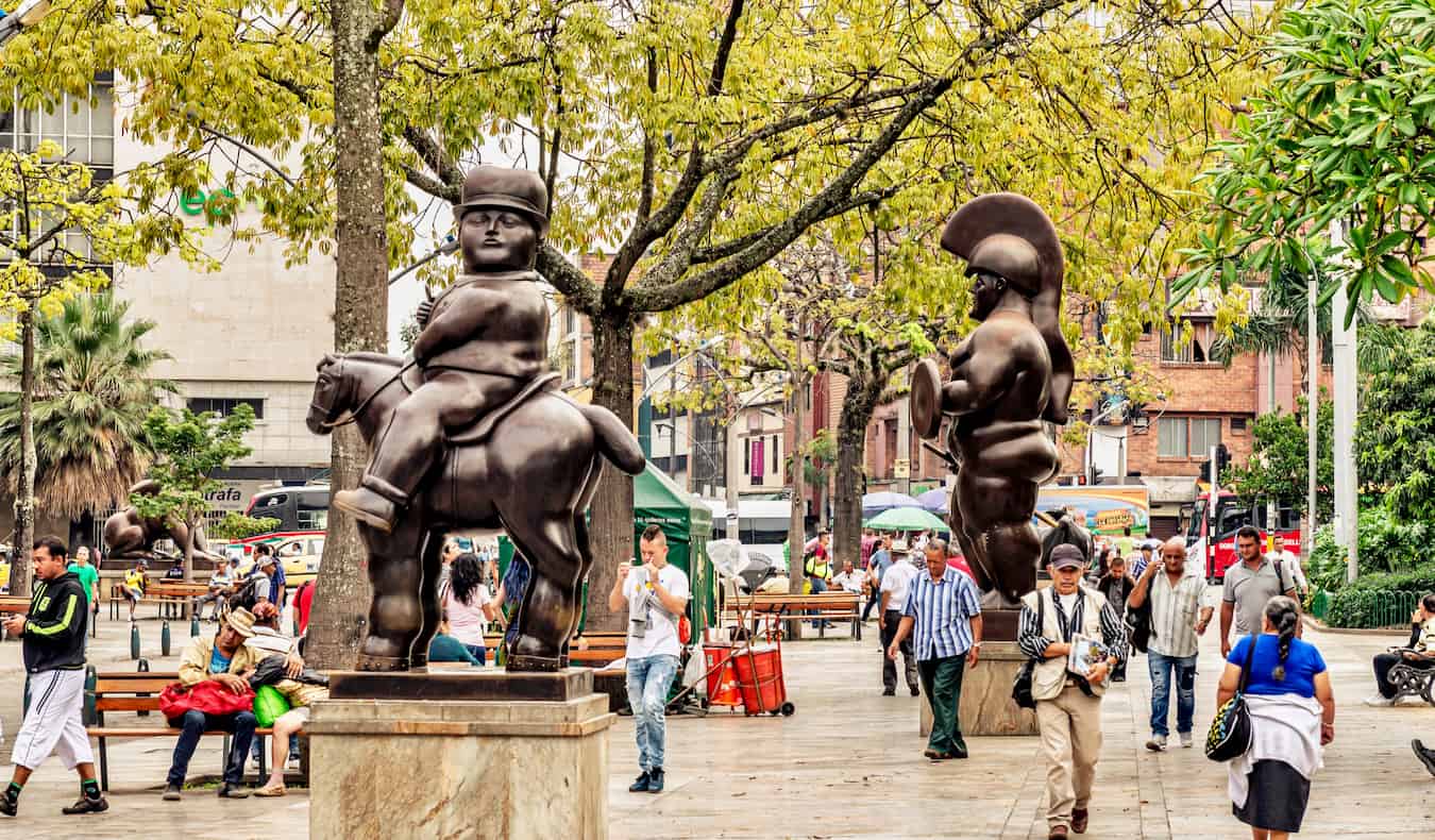 Botero statues and people out walking the streets of Medellin, Colombia