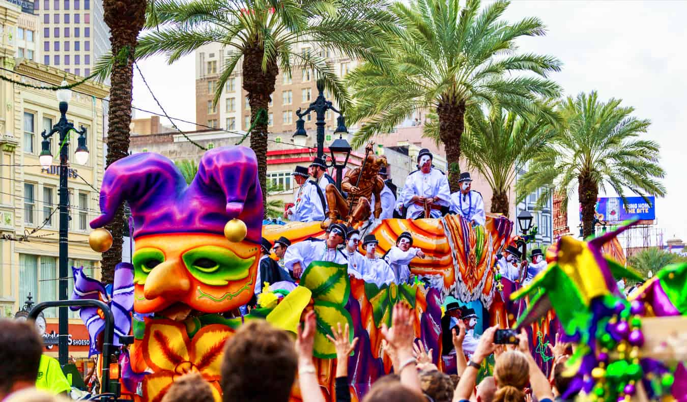 People celebrating Mardi Gras during a wild parade in New Orleans