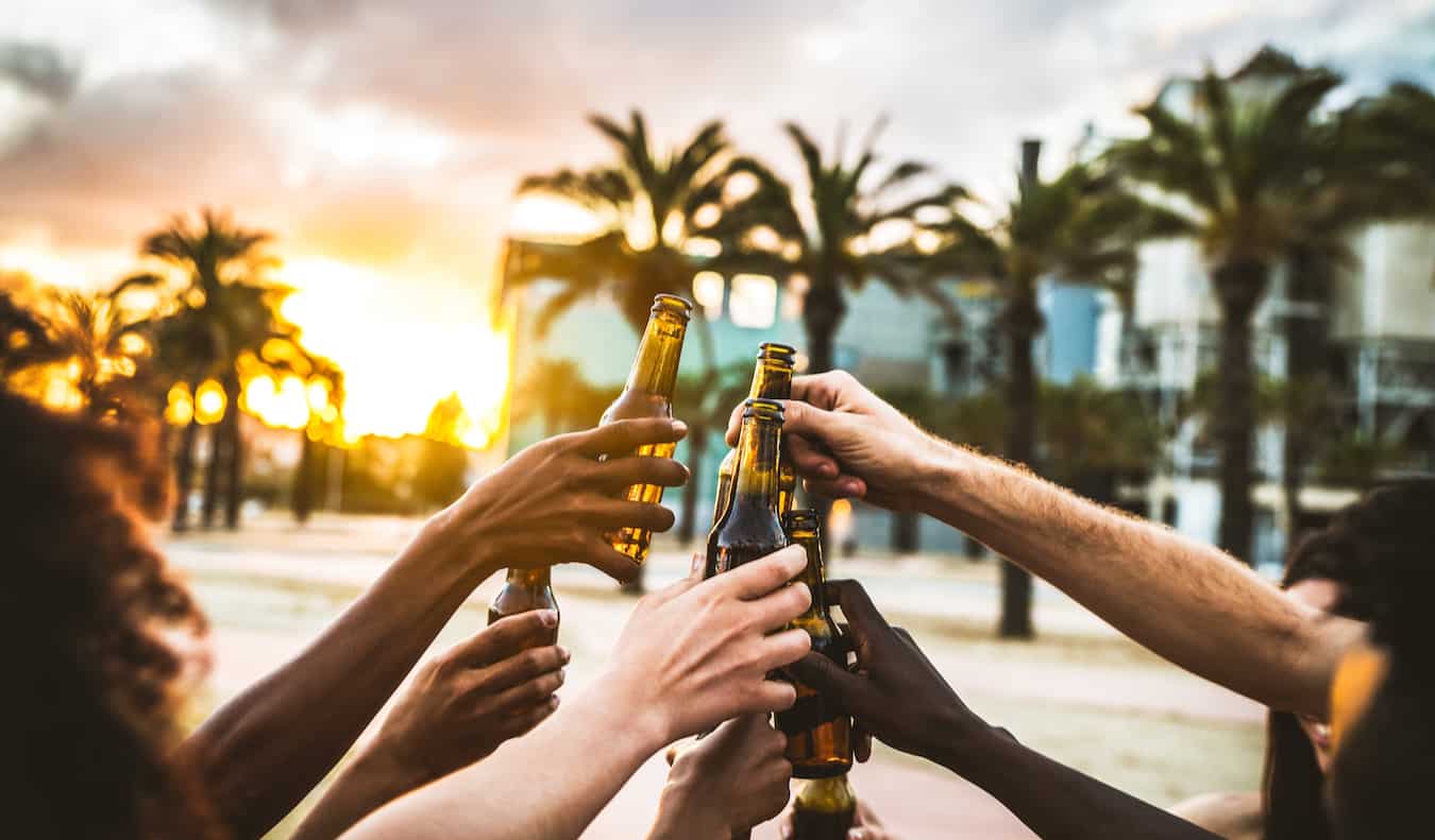 Travelers hanging out together and having a beer during a night out