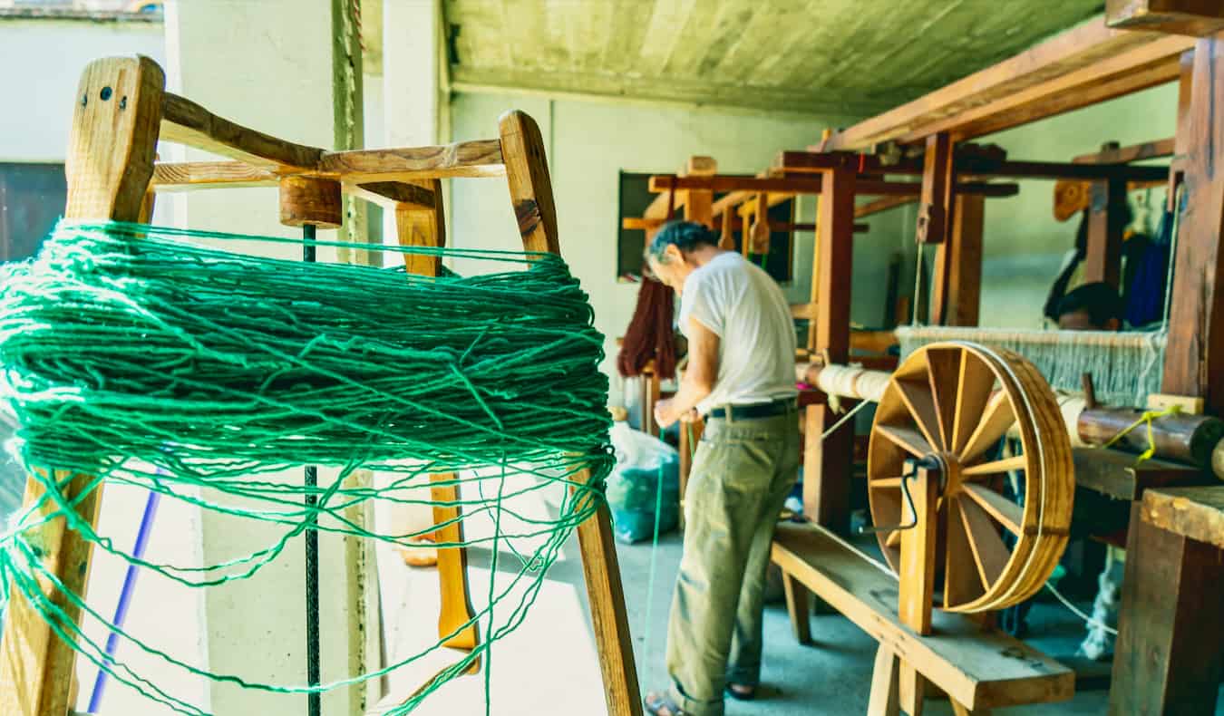 A mean weaving a rug in a small town near Oaxaca, Mexico