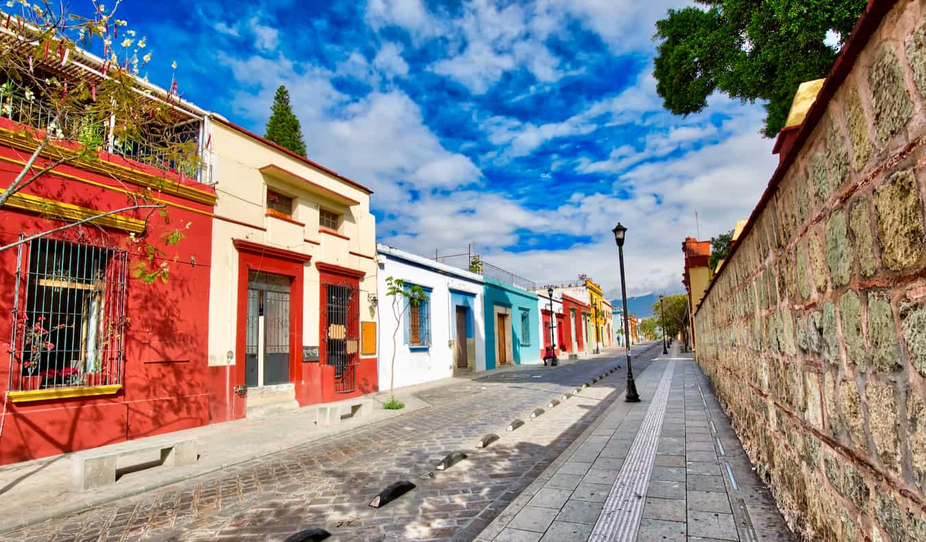 A quiet, empty street painted in bright colors in the beautiful city of Oaxaca, Mexico