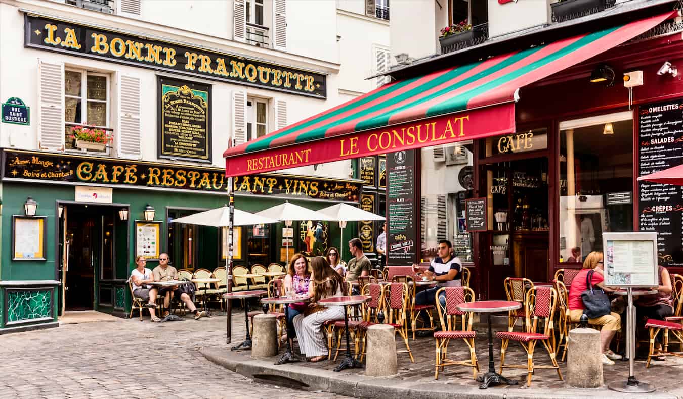 People enjoying the classic French cafes of beautiful Montmartre in Paris, France