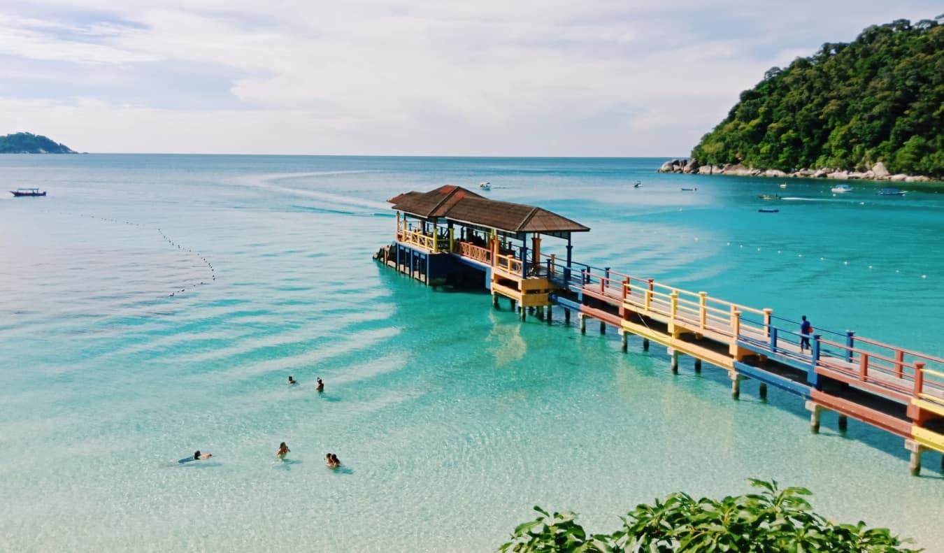 Colorful jetty sticking out into the clear turquoise waters off a beach in the Perhentian Islands, Malaysia