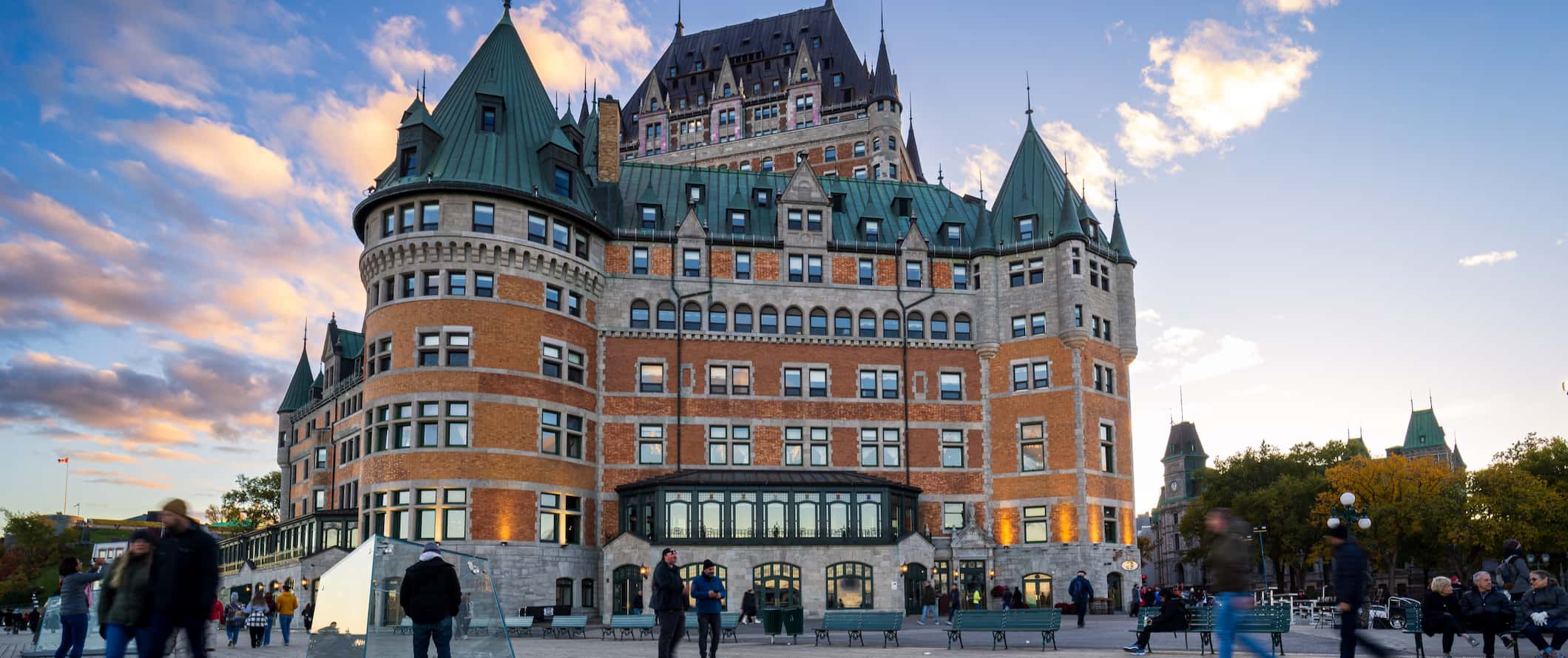 A view overlooking downtown Quebec City in Canada as people stroll around a terrace near the Chateau