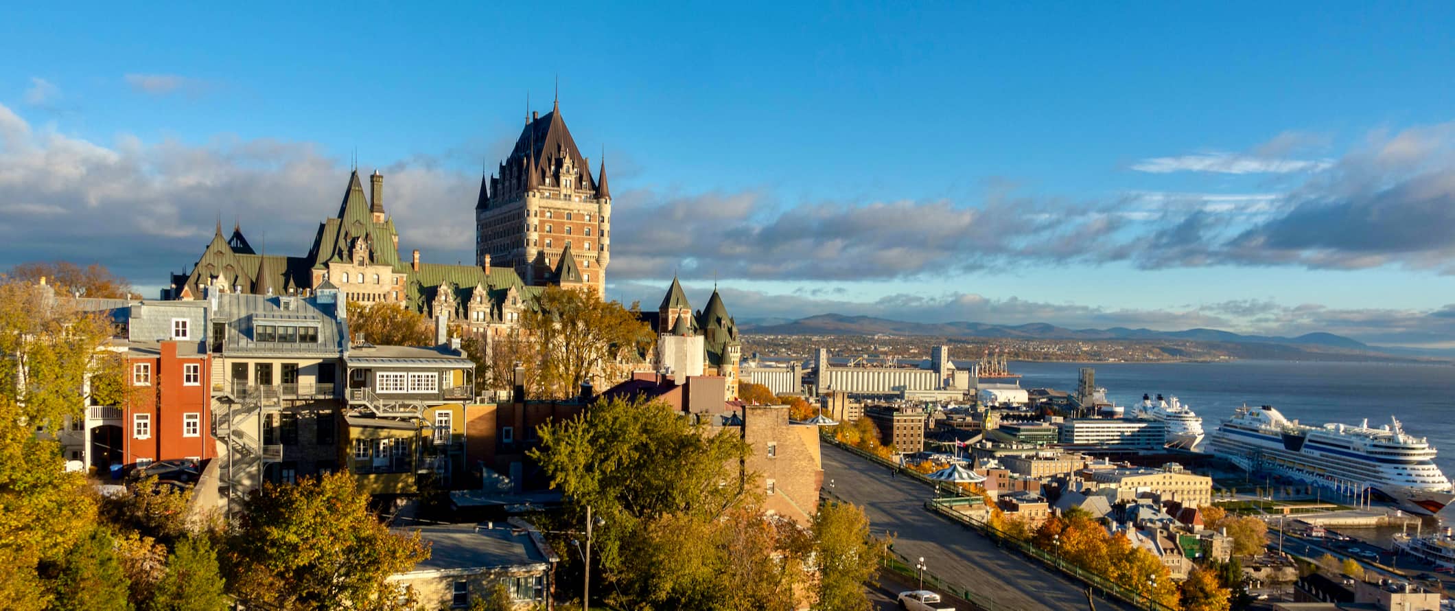 A view over the skyline of Quebec City, Canada with a towering historic chateau in the distance