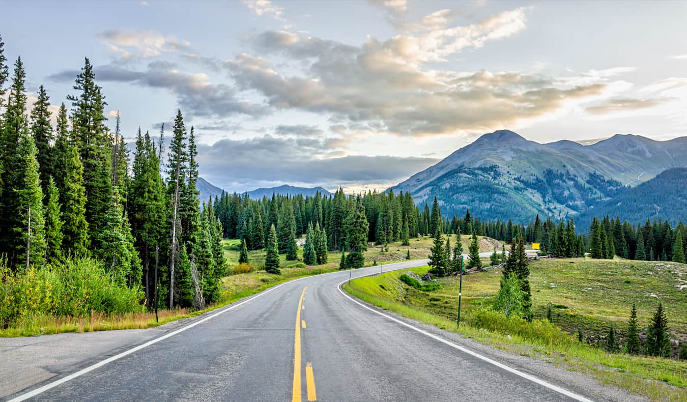 The wide open road on a road trip through a beautiful natural landscape abroad