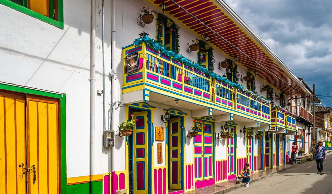 bright streets in Salento, Colombia with doors painted yellow, pink, and blue