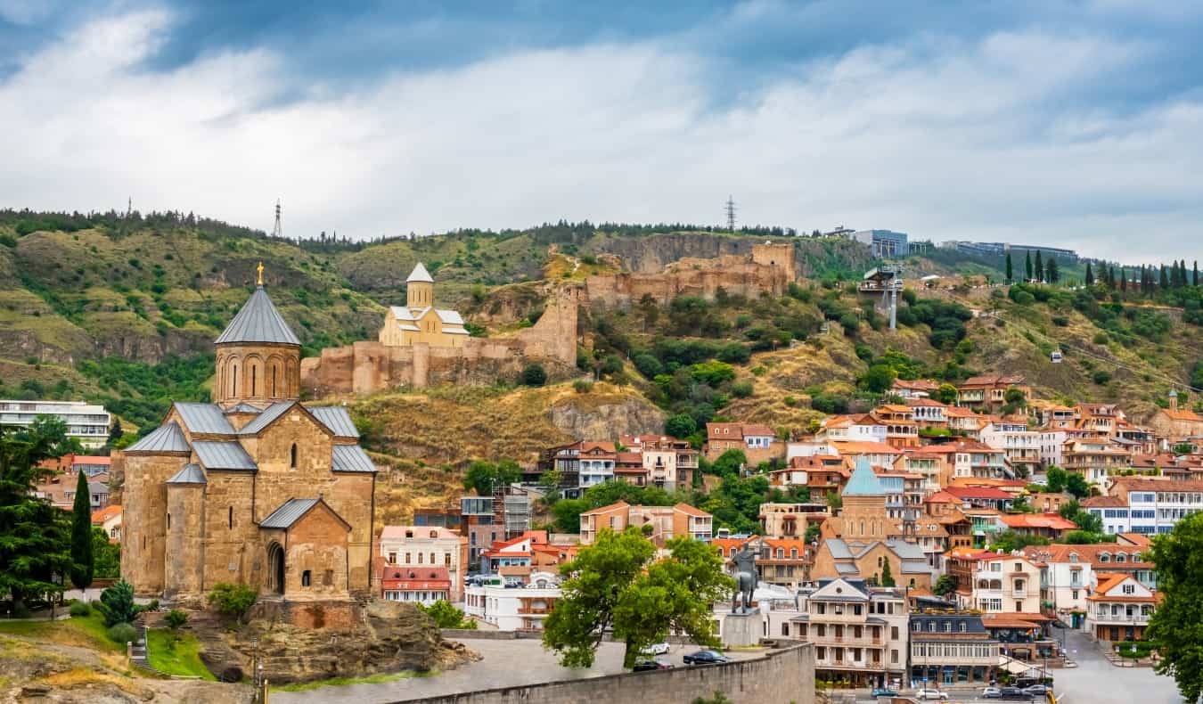 Tbilisi Old Town with traditional homes, several churches, and city walls set into the hills