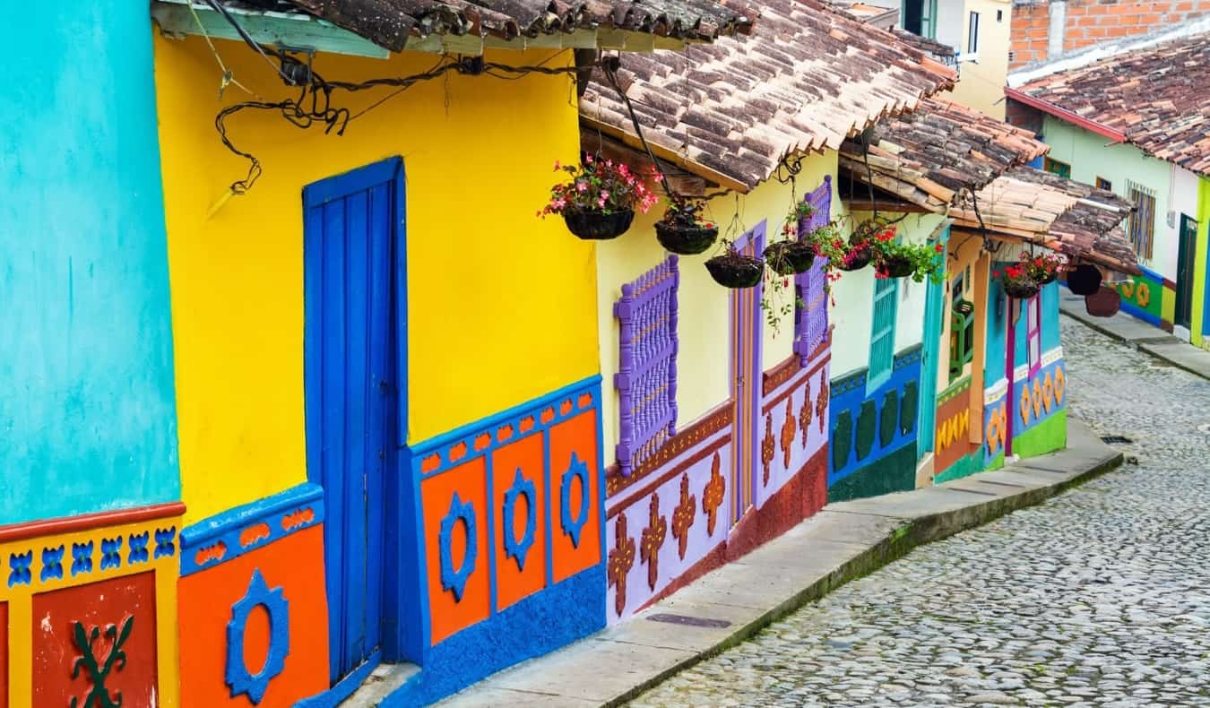 Colorful houses along a hilly cobblestone street in Bogota, Colombia