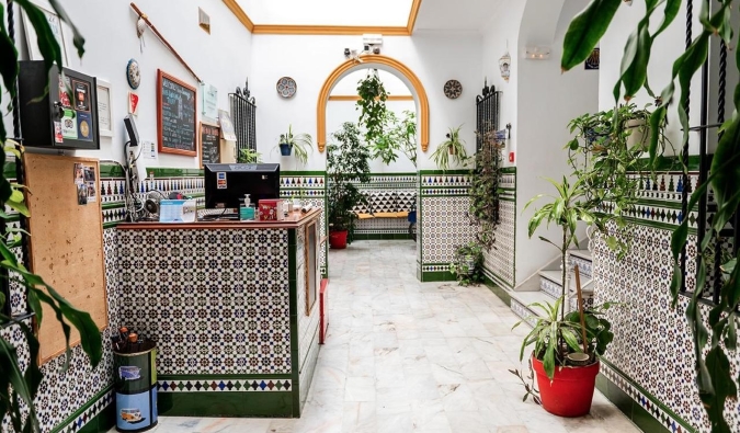 The traditionally tiled reception zone and lobby of Triana Hostel in Sevilla, Spain