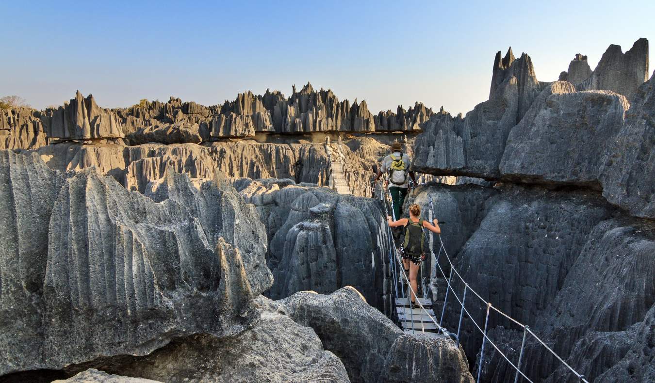 People walking on a rope bridge near a huge gorge near Tsingy in Madagascar