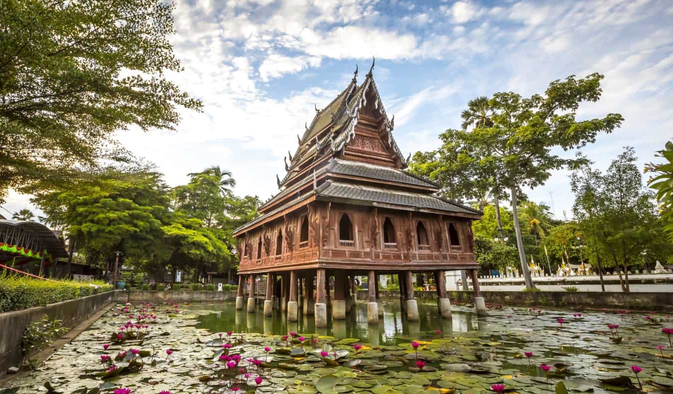 Bright Buddhist temple on stilts above a lotus pond in Ubon Ratchathani in Isaan, Thailand