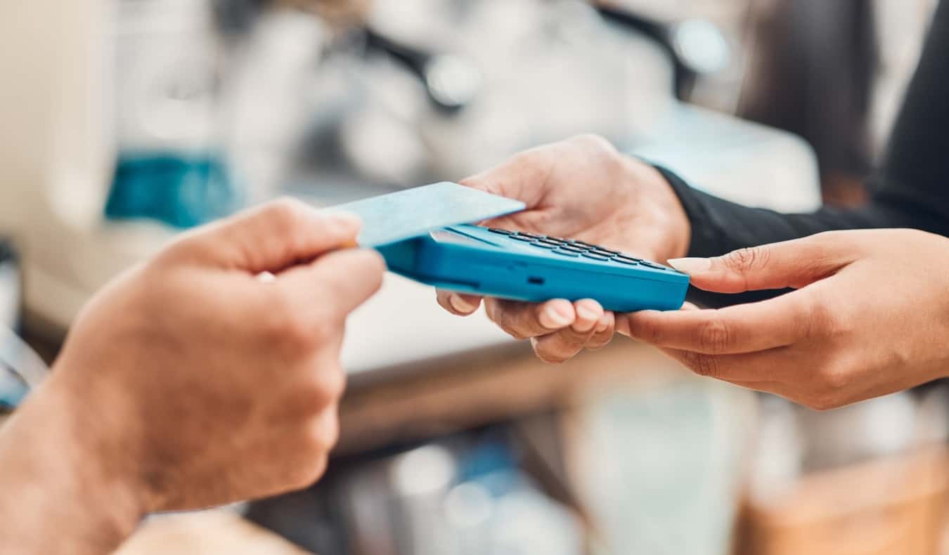 person tapping a credit card to make a purchase