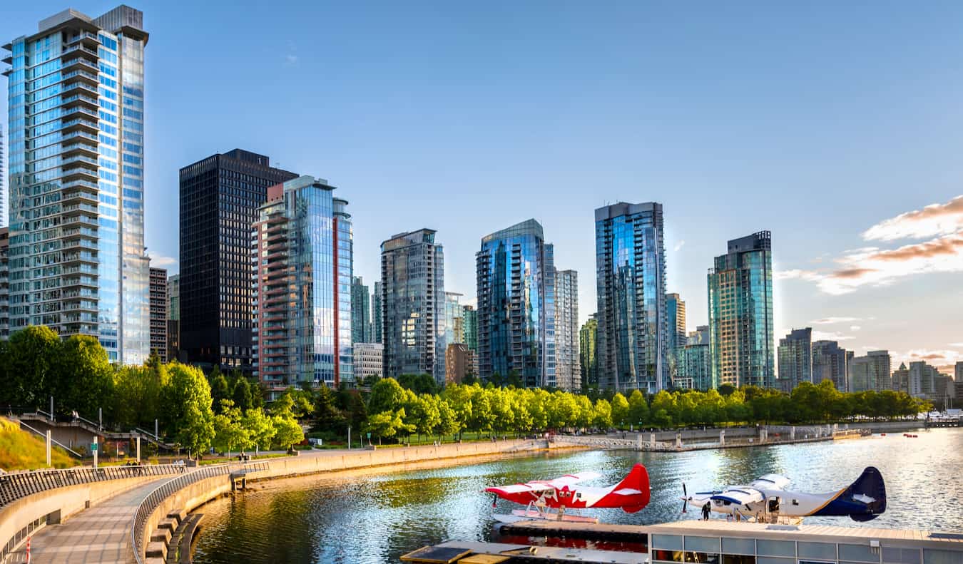 Stunning skyline of Vancouver, Canada seen from above at sunset with mountains in the distance