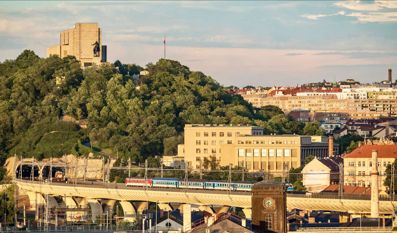 The view of Vitkov Hill over Prague, featuring a towering statue and plenty of greenery