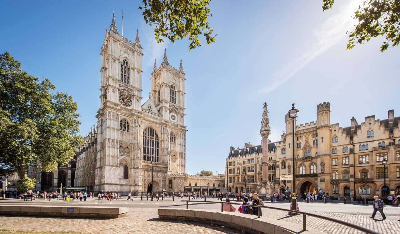 People crossing the street in front of Westminster Abbey in London, England