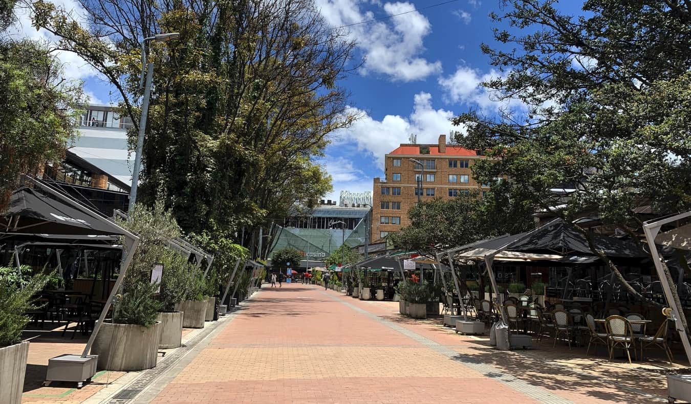 Pink pedestrianized street lined with outdoor cafes in Zona Rosa, Bogotá, Colombia