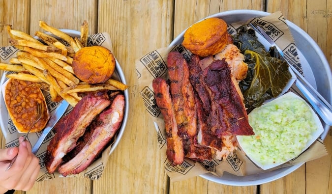 An overhead view of two heaping plates of BBQ with Southern style sides in Raleigh, North Carolina