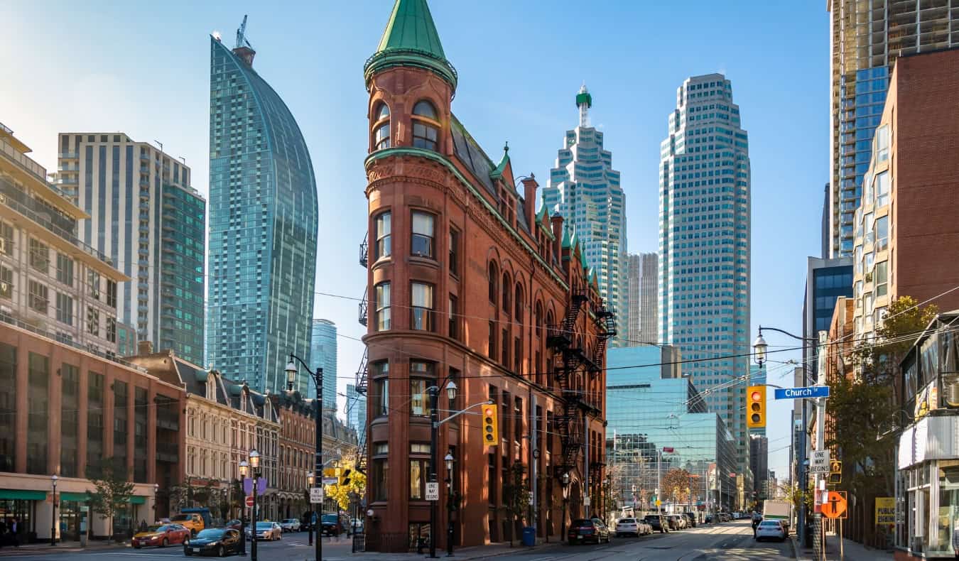 Streetscape in Toronto, Canada, showing the iconic flatiron building and other skyscrapers in the background