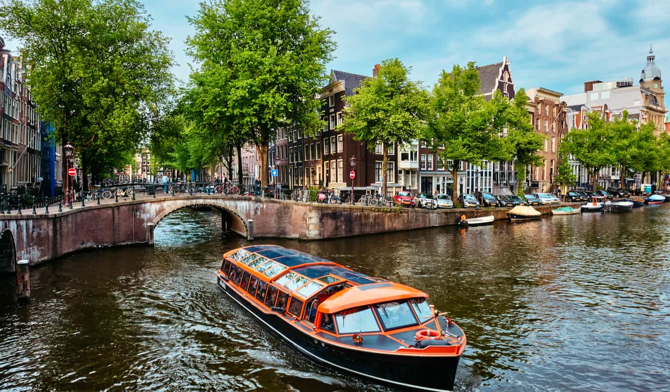 A boat tour of the canals of Amsterdam on a sunny day