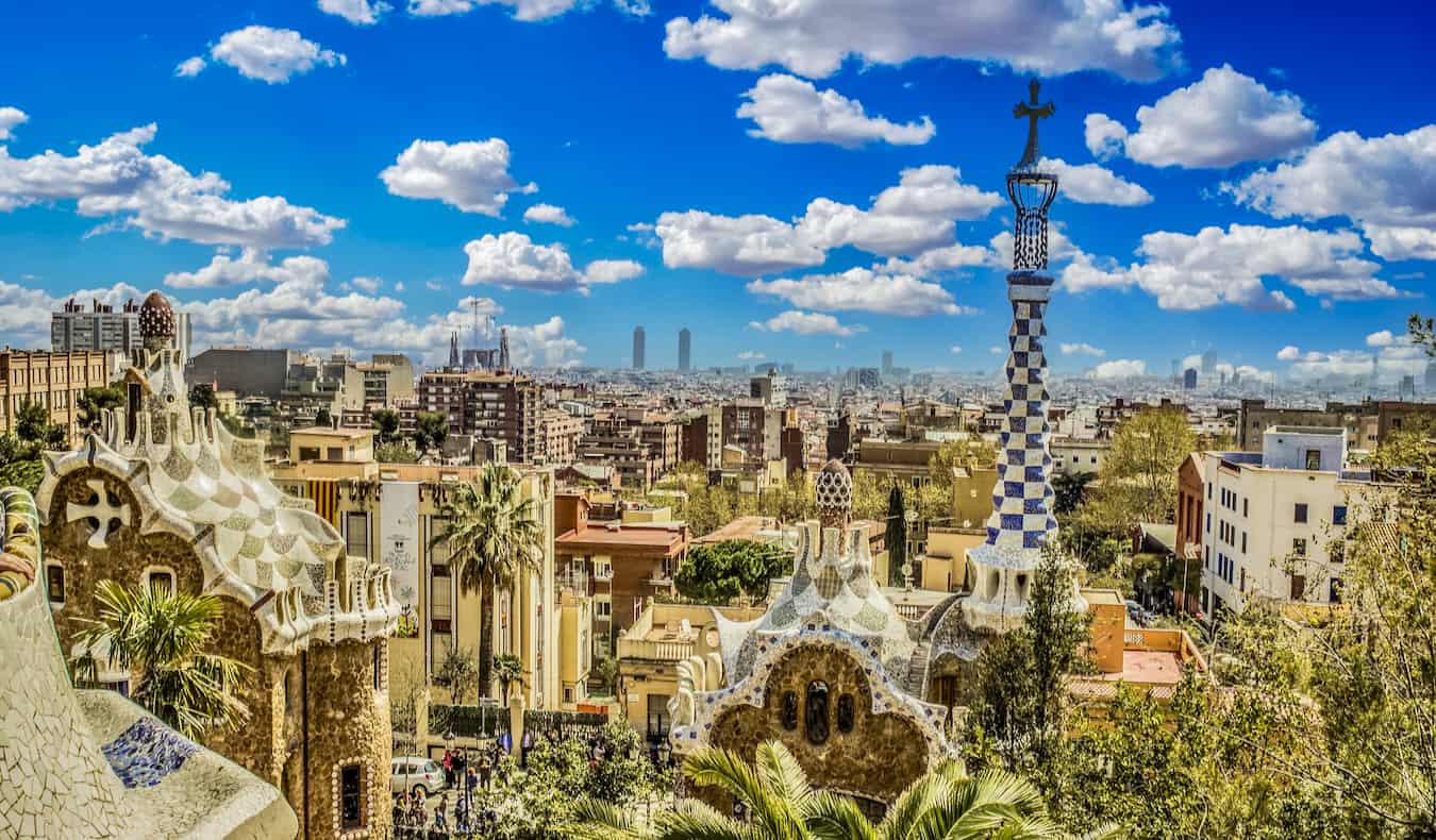 A blue sky over Park Guell in sunny Barcelona, Spain with the city skyline the background