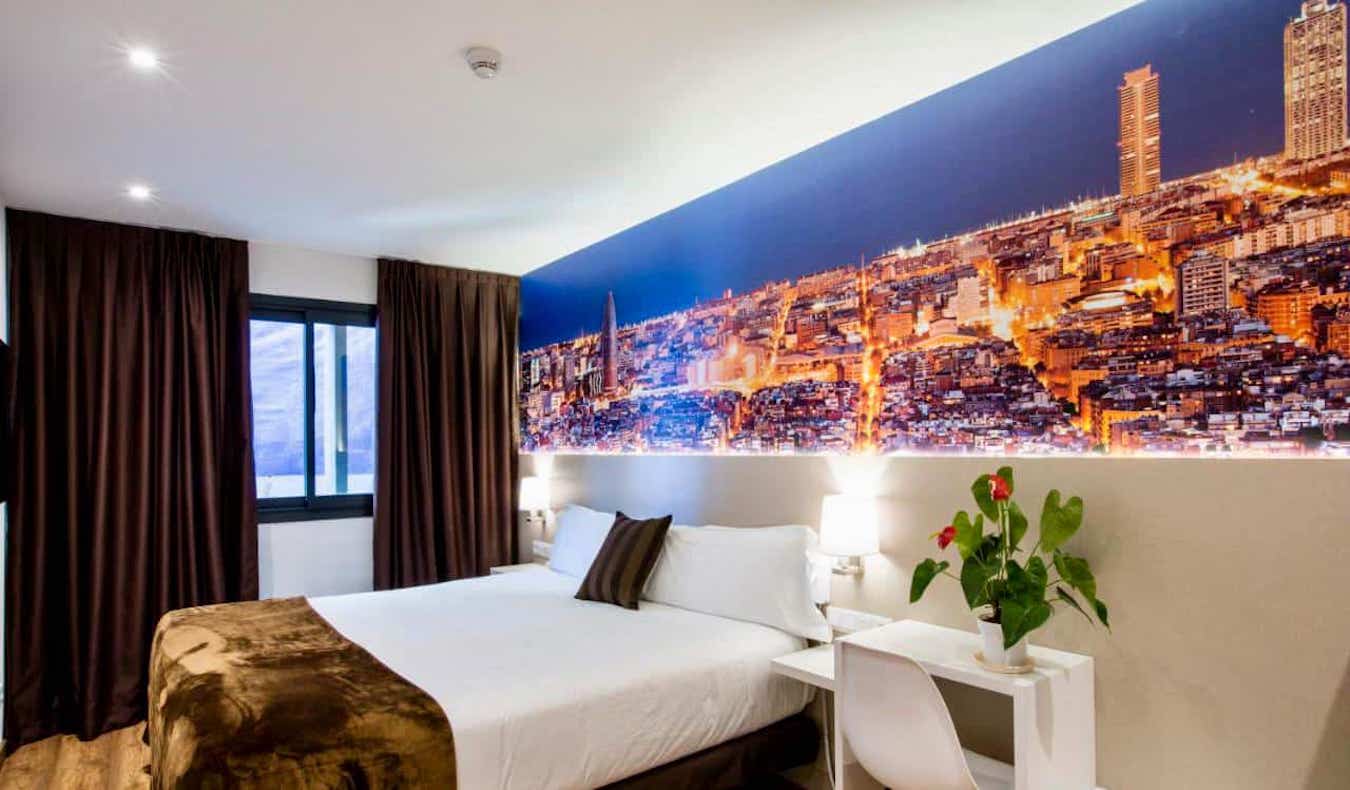 A large hotel room with a large photograph of the city at Hotel BestPrice in in Barcelona, Spain