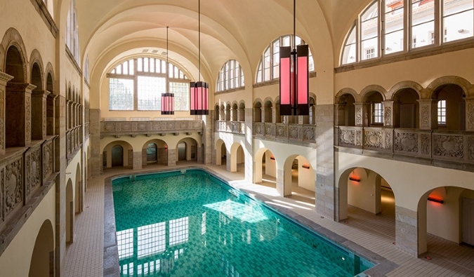 The historic swimming pool, with a domed ceiling and lots of natural light coming in from the windows at Hotel Oderberger in Berlin, Germany