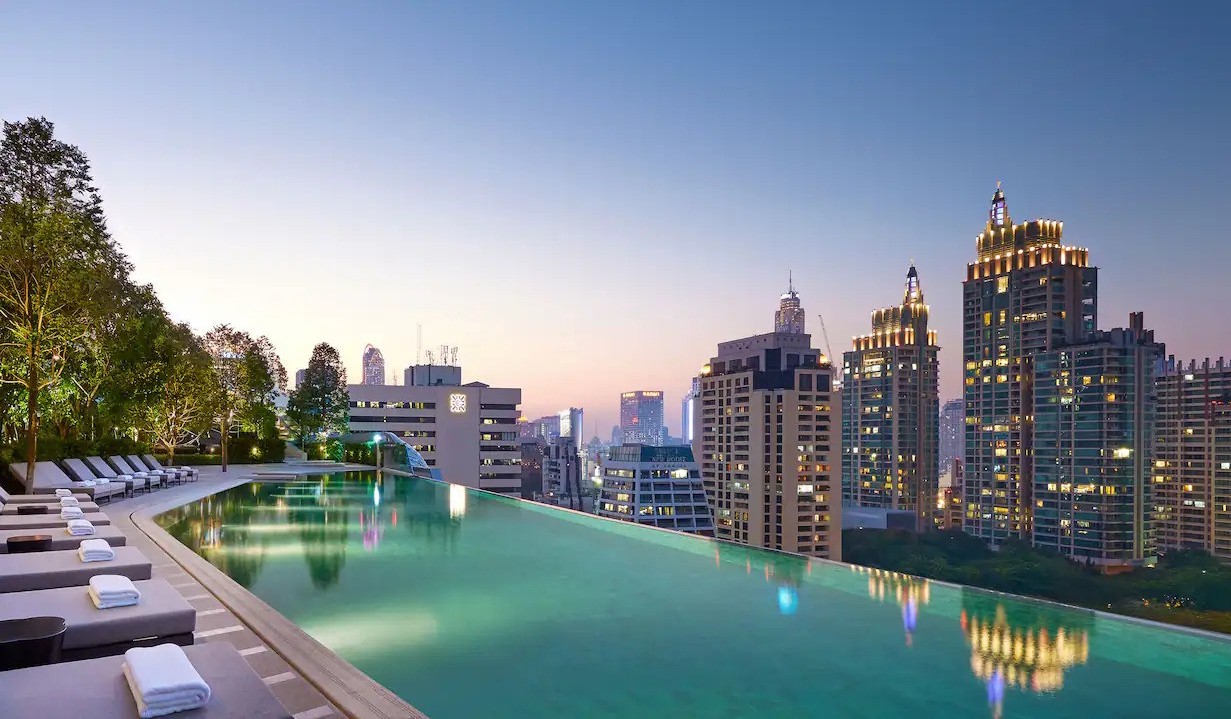 The infinity pool at the Park Hyatt at dusk overlooking the skyline of Bangkok, Thailand