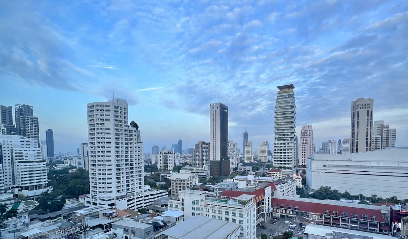 Towering skyline of downtown Bangkok, Thailand with bright blue sky