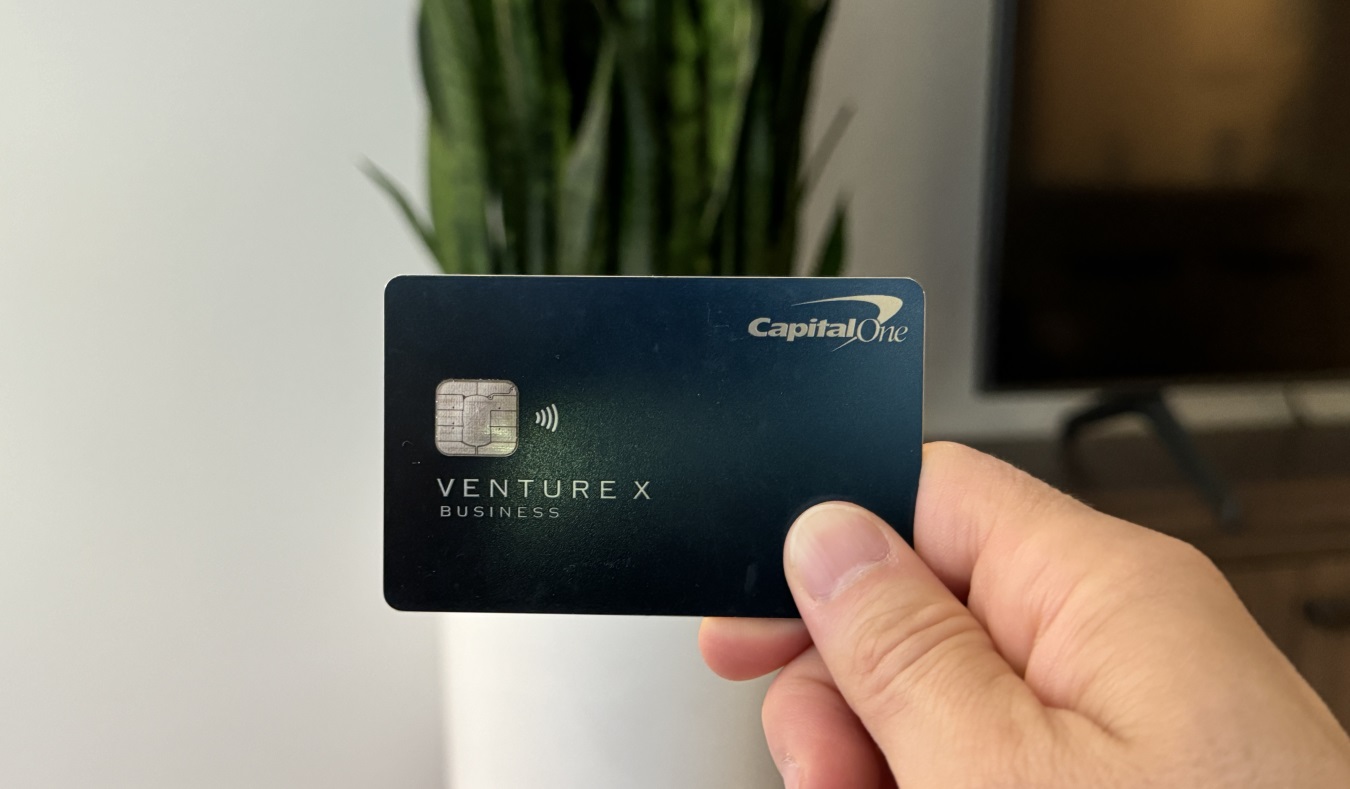 Nomadic Matt holding up his Capital One Venture X business card