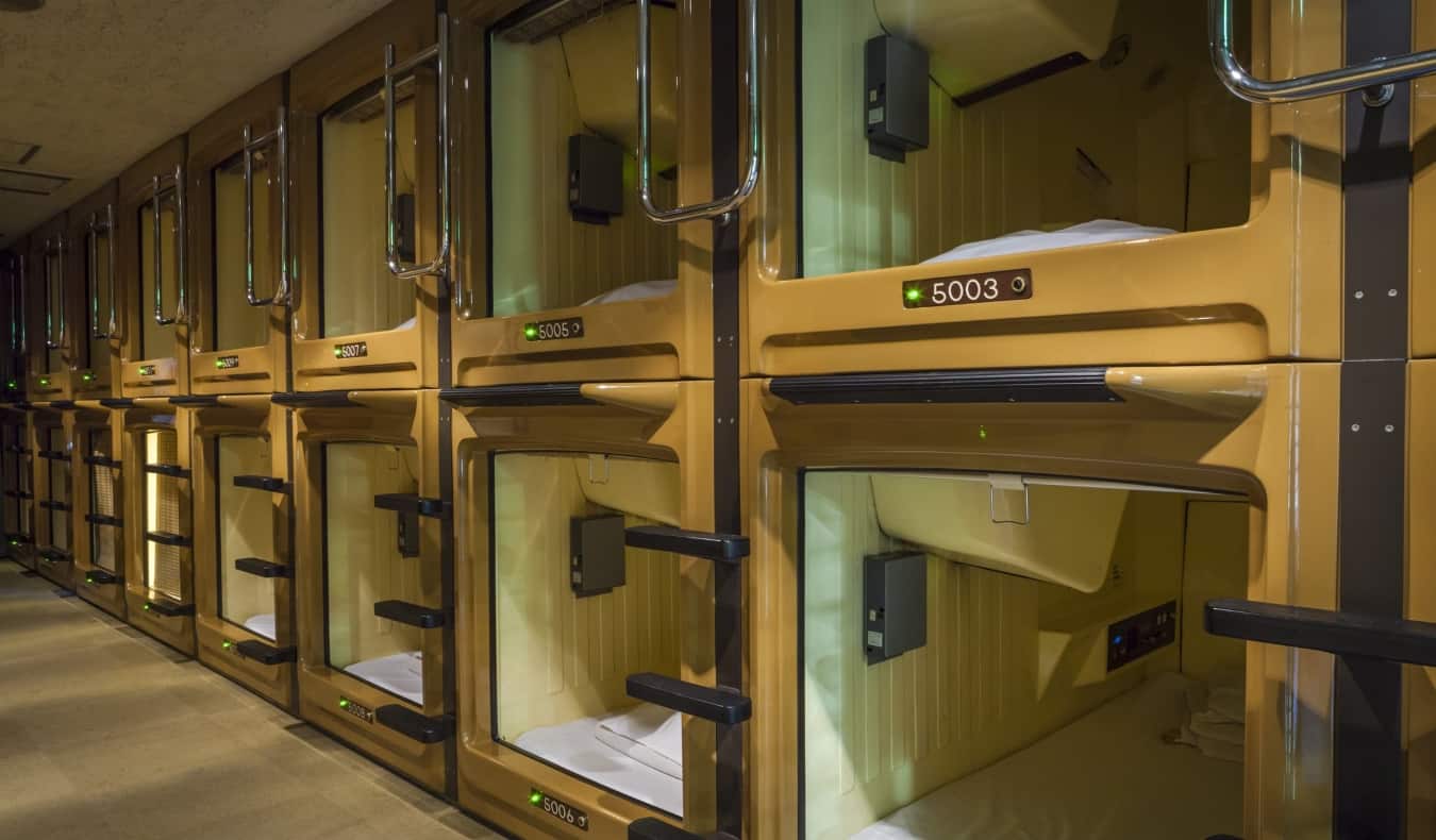 A row of sleeping capsules at a capsule hotel in Japan
