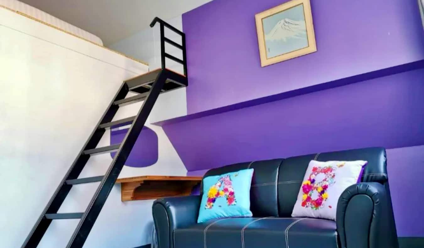 A funky purple-painted room at Dozy House hostel in Chiang Mai, Thailand