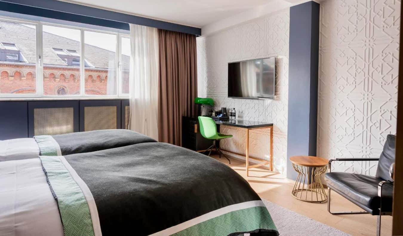 A stylish hotel room with a large bed at Hotel Skt Petri in Copenhagen, Denmark
