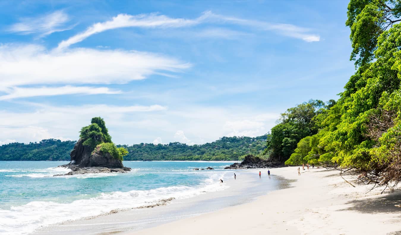 The wide, white sandy beach along the coast of popular Manuel Antonio in Costa Rica