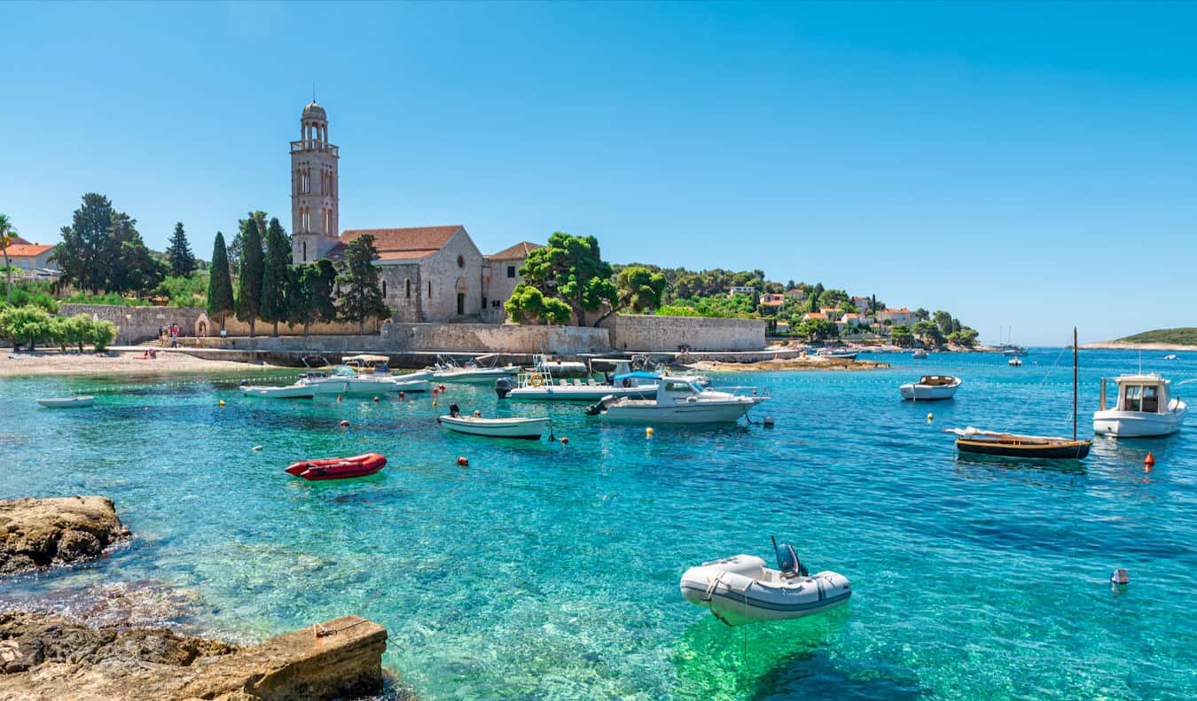 The beautiful waters in a bay on Hvar, Croatia on a sunny summer day with old buildings in the background