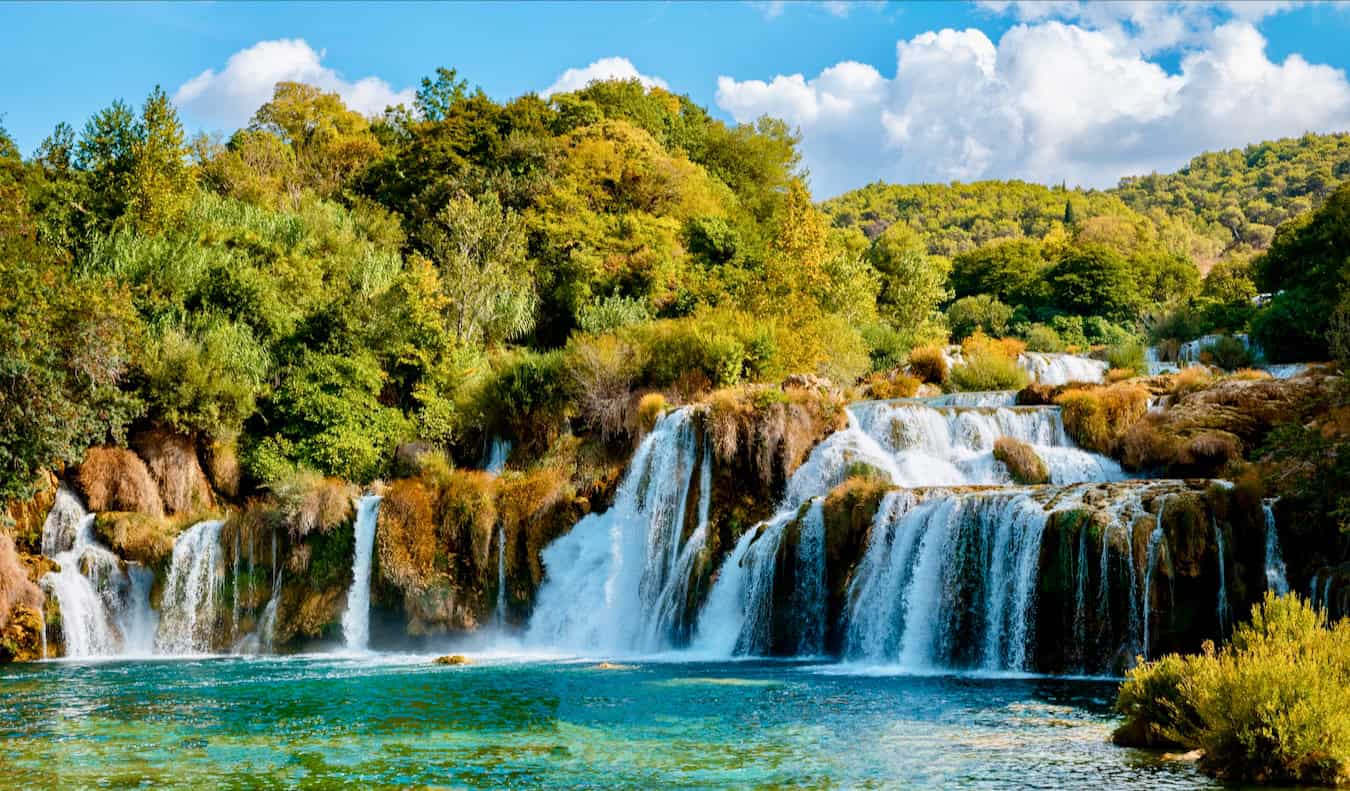 The beautiful Krka waterfalls in a national park in Croatia, surrounded by lush greenery