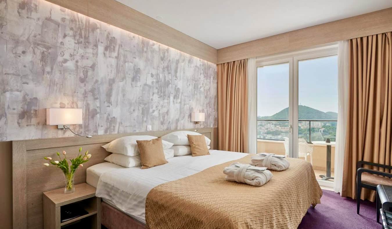 A huge, comfy bed in a big hotel room at Hotel Adria in Dubrovnik, Croatia
