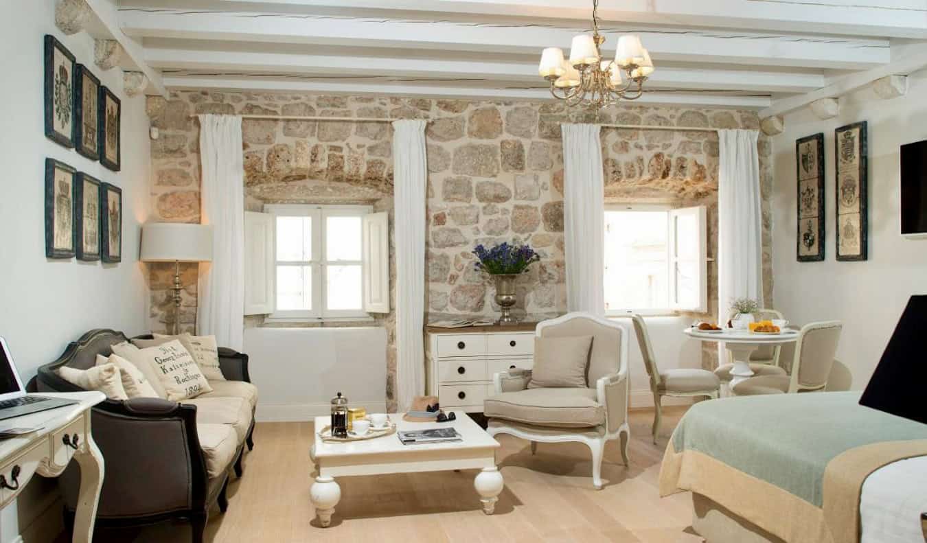 Spacious hotel rooms at the St. Joseph Hotel with exposed brick and pastel colors in Dubrovnik, Croatia