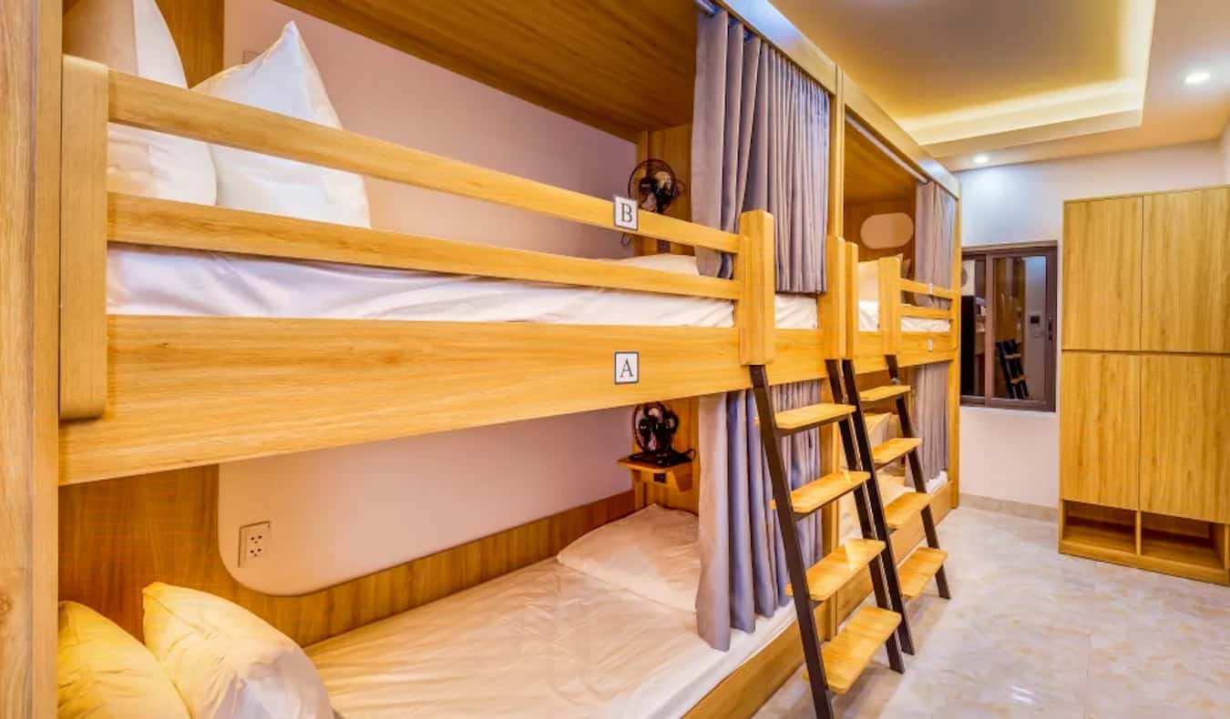 A large dorm room with bunk beds at the One Hostel in Hanoi, Vietnam