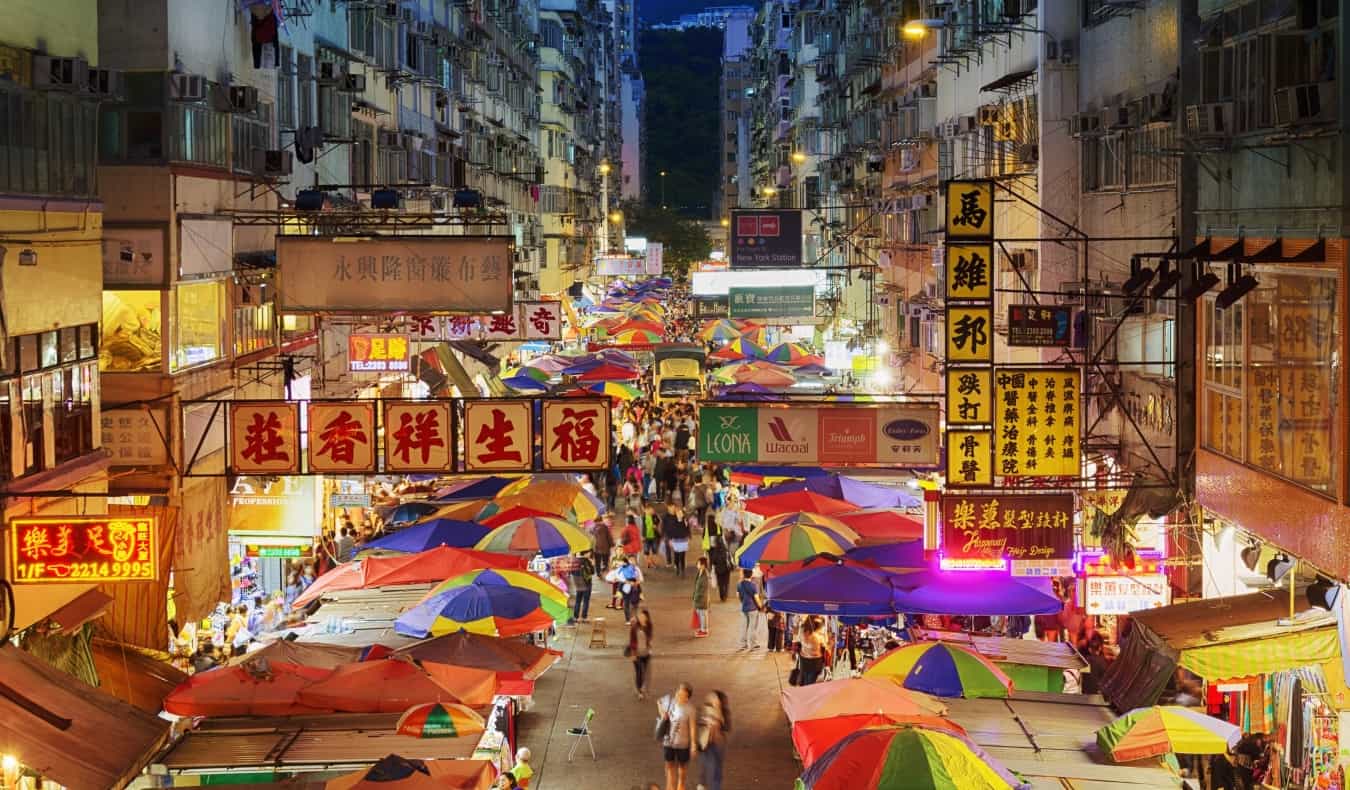 market stalls set up in a street at night in Hong Kong