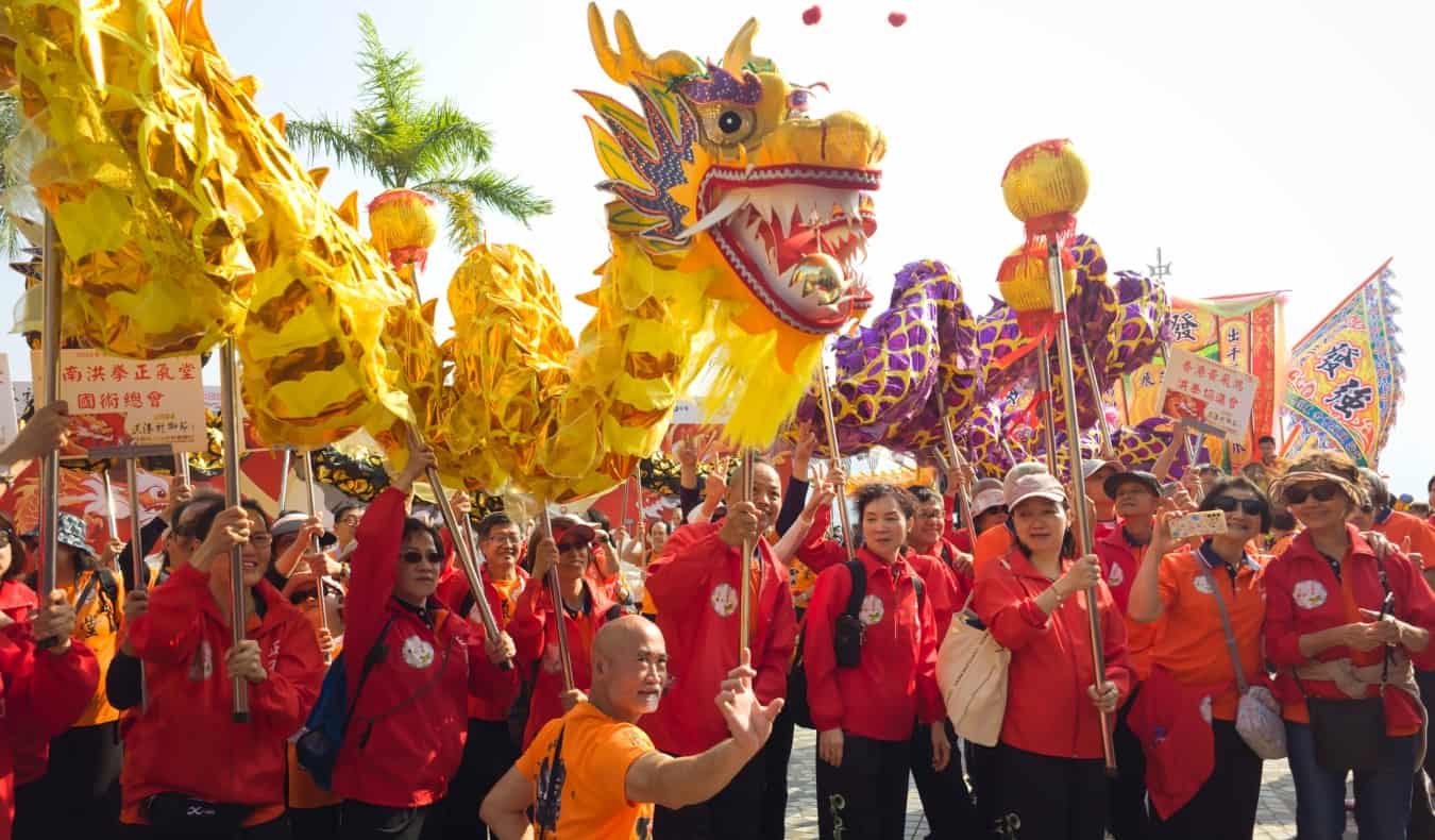 People hold up large paper dragons at a festival in Hong Kong