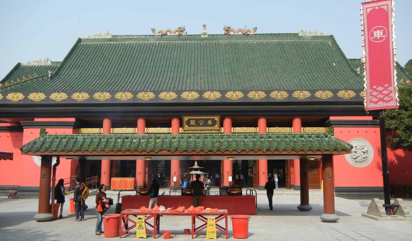 The Sha Tin Che Kung Temple with its red exterior and green terracotta roof in Hong Kong