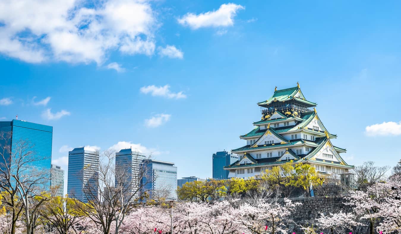 the historic Osaka Castle in Osaka Japan towering over the city on a sunny summer day