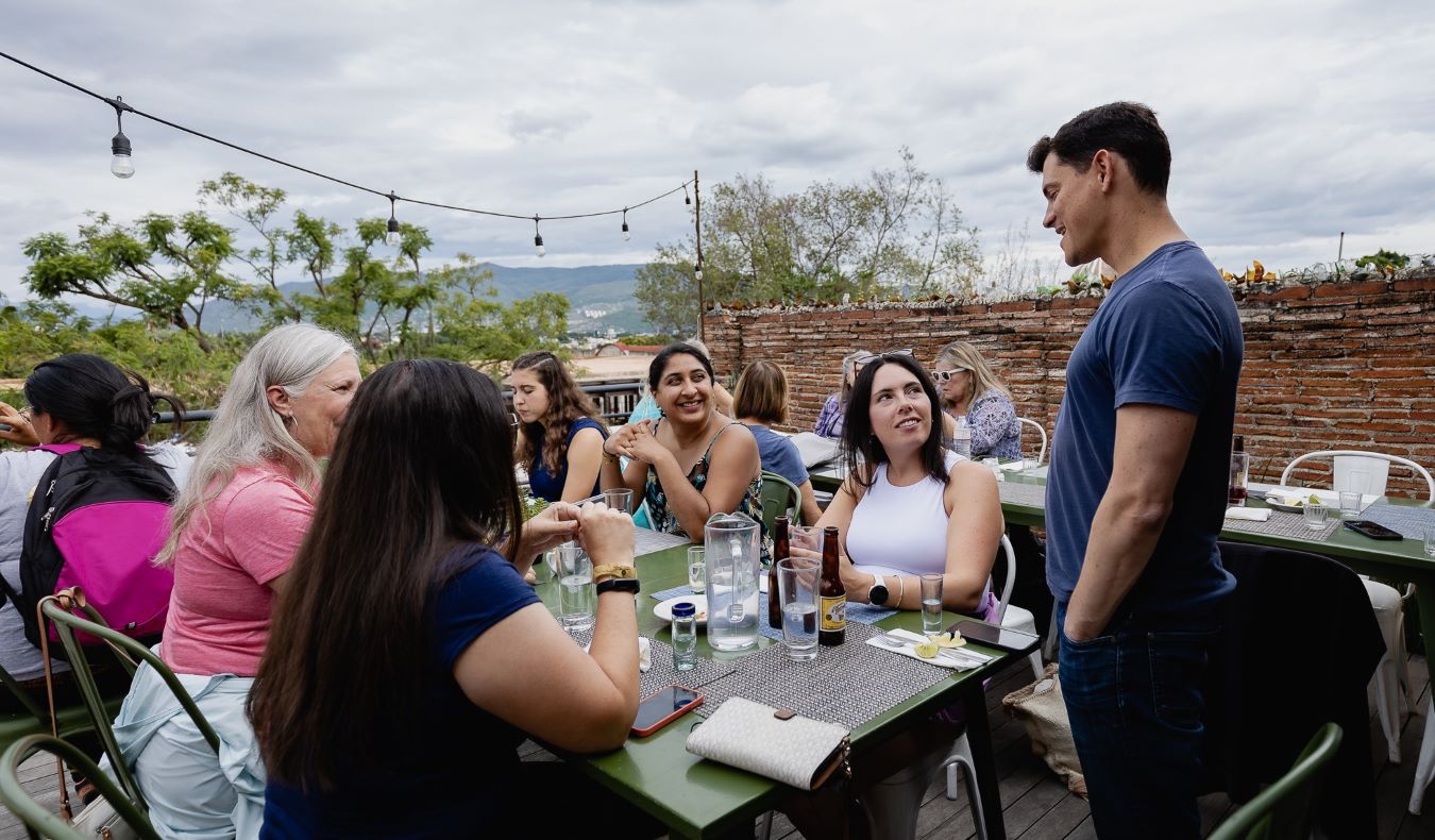 Nomadic Matt talking to a table of people at a restaurant in Oaxaca, Mexico