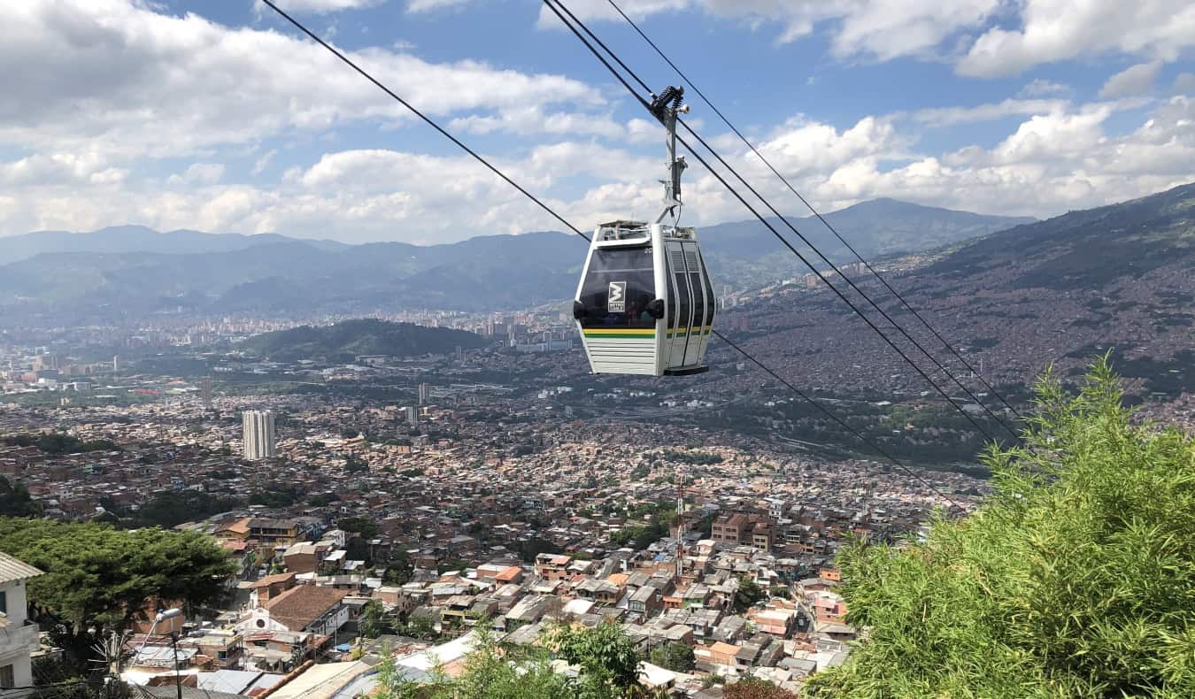 skyline of Medellin, Colombia, with a cable car running through the foreground